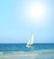 Beach view with big sun and sail