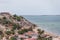 Beach view with fishermen and traditional Angolan boats, in Luanda beach, ghetto as background