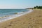 Beach view. Seashore texture. line water foam over clean sand and blue water. Hirozontal