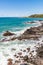 Beach view with waves and rocks