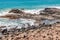 Beach view with waves and rocks