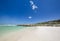 Beach view with white sand, rocks and crystal clear water at Brandfontein - Rietfontein Nature Reserve near Cape Agulhas