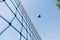 Beach volley ball player jumps on the net and tries to blocks the ball.