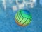 Beach volleyball ball floating in swimming pool. Copy space