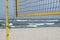 Beach volleyball net on the empty beach, close up