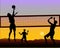 Beach volleyball players at sunset - silhouette