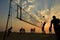 Beach volleyball silhouette at sunset , blurred