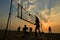 Beach volleyball silhouette at sunset , blurred