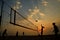 Beach volleyball silhouette at sunset , blurred