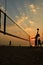 Beach volleyball silhouette at sunset , blurred