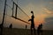 Beach volleyball silhouette at sunset , blurred