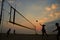 Beach volleyball silhouette at sunset , blurred