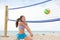 Beach volleyball woman playing game hitting ball