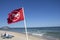 Beach Warning Flag the No Swimming Flag, riptide. clear sky summer beach day. Ocean waters