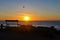 Beach on waterfront, Porto Covo, Portugal at sunset