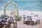 Beach wedding venue setting with flower decoration on arch, panoramic ocean view