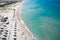 The beach with white sand, beach umbrellas and a large crowd of people, Shooting from a drone