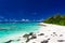 Beach with white sand and black rocks on Rarotonga, Cook Islands