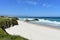 Beach with white sand, cliff and waves. Lugo, Spain.