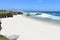 Beach with white sand, cliff and waves. Lugo, Spain.