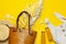 Beach wicker straw rattan women`s eco bag white dress hat golden tropical leaf juice in glass jars straws shells starfish on