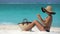 Beach Woman Applying Sunscreen Lotion On Leg At Beach - Spray Bottle
