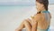 Beach woman applying sunscreen lotion tan oil spray on body shoulders