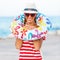 Beach woman happy and colorful wearing sunglasses and beach hat having summer fun during travel holidays vacation