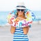 Beach woman happy and colorful wearing sunglasses and beach hat having summer fun during travel holidays vacation