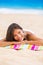 Beach woman thinking looking up at copyspace. Multiracial Asian Chinese / Caucasian female girl relaxing on beach towel