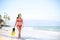 Beach woman walking by ocean - bikini and snorkel