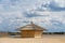 Beach wooden cabin with fluffy clouds