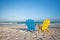 Beach wooden colorful chairs for vacations on