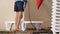 Beach worker washes the beach loungers deck chairs with a jet of water.