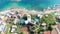 Beach world famous as a surfer\'s paradise. Deck chairs. Ocean surf and waves. Stone cliffs. Aerial view. Greece, Crete