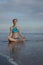 Beach yoga practice in Bali. Lotus pose. Padmasana. Hands in gyan mudra. Meditation and concentration. Zen life. Relaxation of