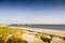 Beach in Zeeland and the famous flood barrier Oosterscheldekering of the Delta works in the background on a sunny summer day. The