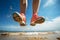 Beachbound joy Womans feet capture the thrill of jumping