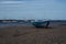 Beached blue wooden fishing tender