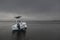 Beached boat awaits a dark storm