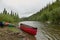 Beached canoe and equipment on river in Alaska