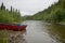 Beached canoe on remote, wild Alaskan riverbank