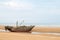 Beached fishing boat at low tide