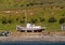 Beached white-red sloop at Otway Sound, Patagonia, Chile