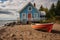 beachfront cottage with a boat parked beside it on the sand