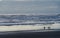 Beachgoers newr Westport Jetty watching surf during sunset