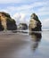 Beachscape in Tongaporutu, New Zealand featuring the majestic Three Sisters and Elephant Rock