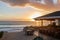 beachside eatery with outdoor seating and stunning sunset view