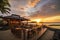 beachside eatery with outdoor seating and stunning sunset view