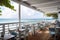 beachside eatery, with view of the ocean and waves, serving mouthwatering seafood dishes